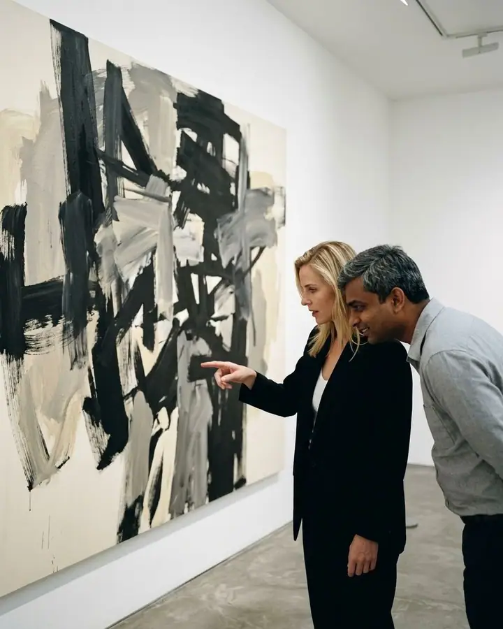 AI example of a couple looking at a large abstract painting in a white gallery