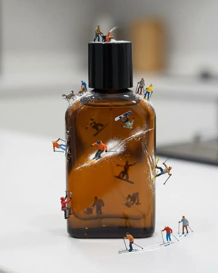 Tiny skiers and snowboarders on the surface of an everyday object as if it were a slope