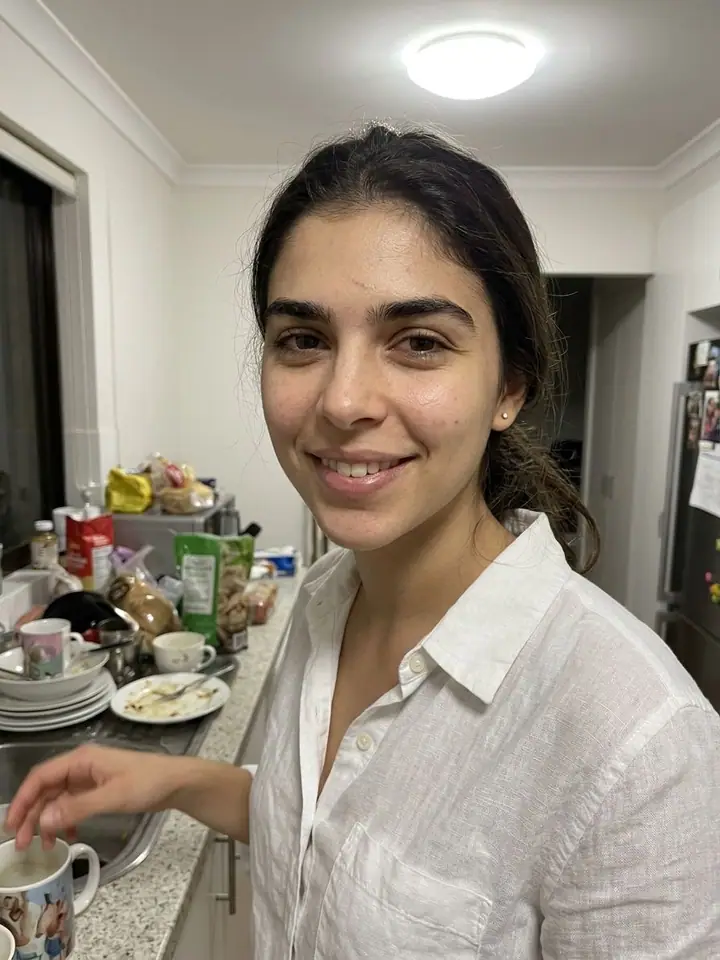 AI example of an unpolished candid kitchen snapshot of a woman with natural skin