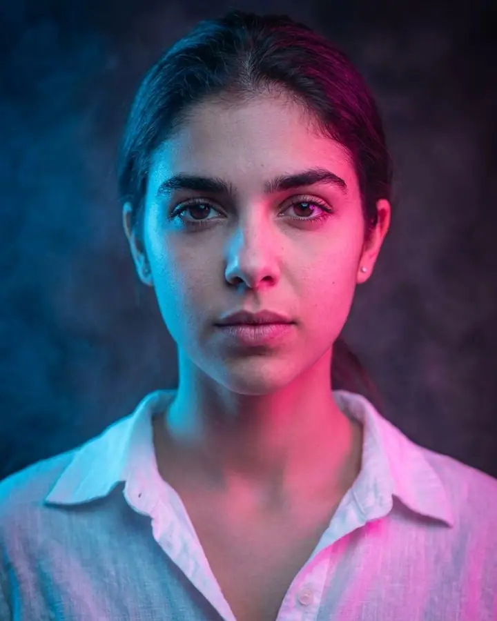 AI example of a woman lit with blue and pink gels through haze