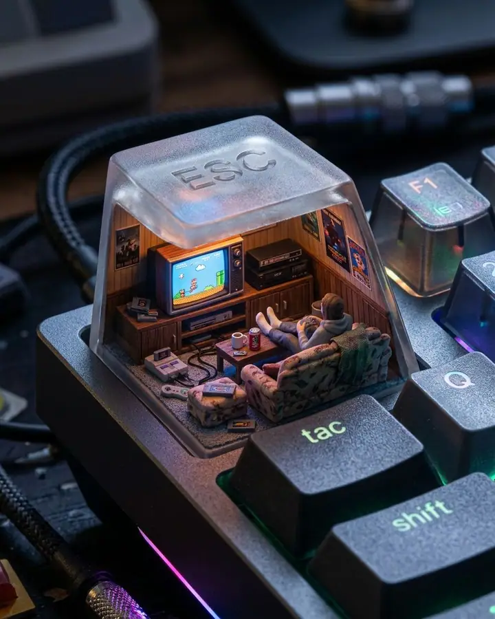 Miniature 90s living room with a glowing game screen inside an ESC keycap