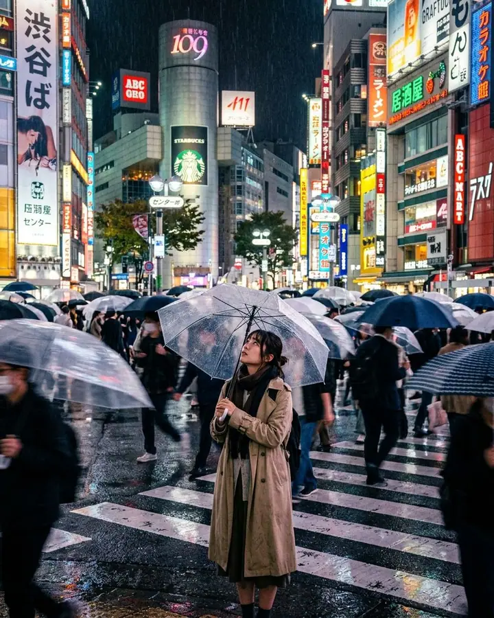 Grainy digital photo of a woman with a clear umbrella in a rainy neon Tokyo crosswalk
