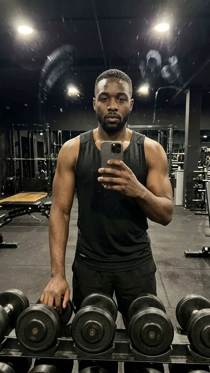 AI example of a gym mirror selfie of a man by a dumbbell rack